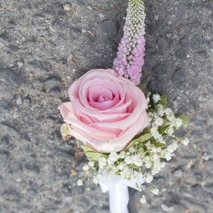 Kytice-korsáž pro ženicha z růžové růže a gypsophily a veronica